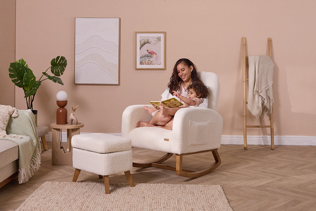 Woman reading to a child on the Luca nursing chair with smooth, calming rocking motion