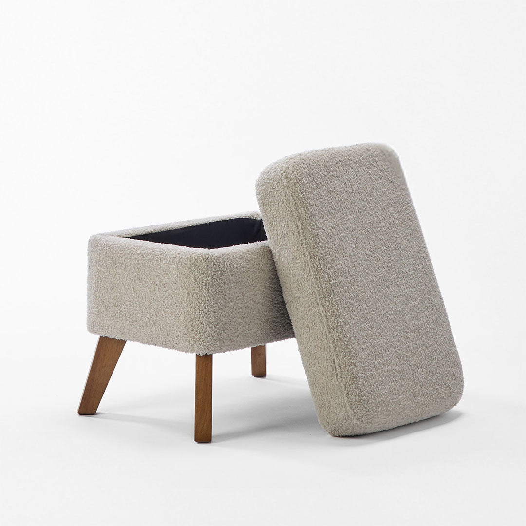 Luca footstool opened showcasing the storage space and wooden legs in a white background.