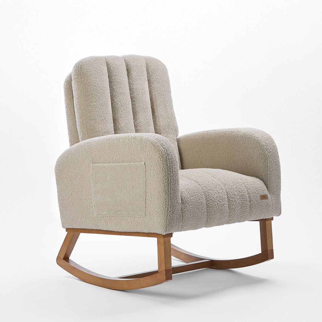 Angle view of the Luca nursing chair and matching footstool in mushroom, showcasing a rounded silhouette, side pockets and rubberwood runners in a white background.