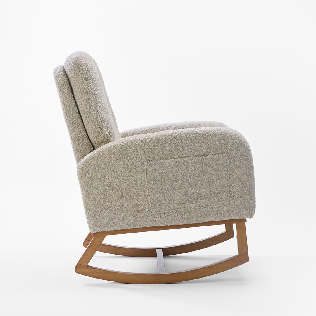 Side view of the Luca nursing chair and matching footstool in mushroom, showcasing a rounded silhouette, side pockets and rubberwood runners in a white background.