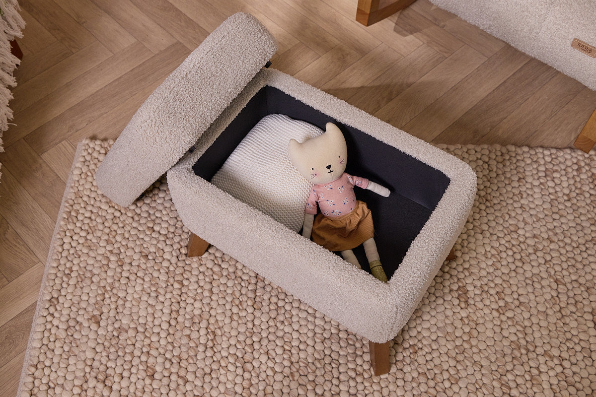 Luca's footstool opened with a plush interior, showcasing its storage capacities, and wooden legs on a carpeted floor.
