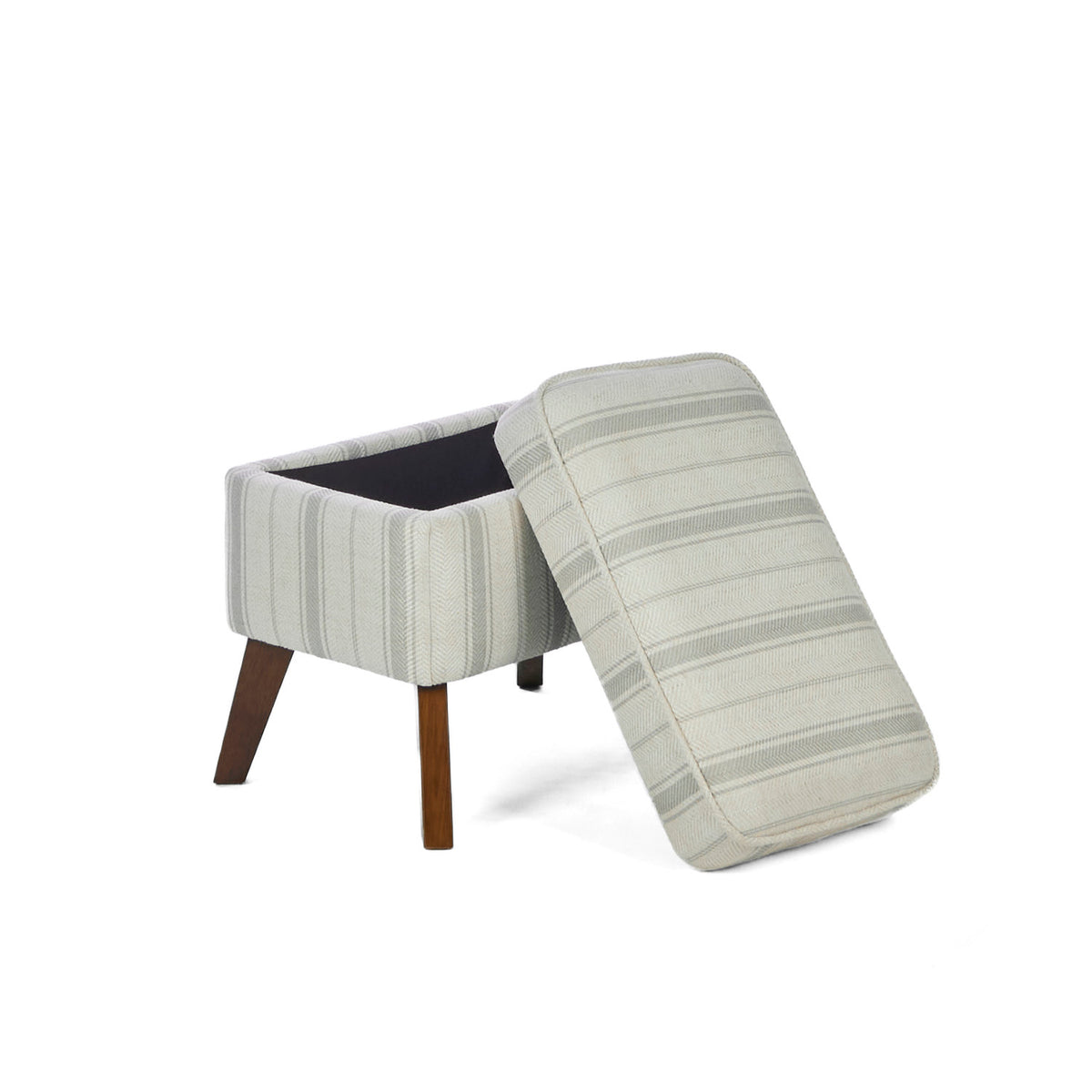 The matching footstool of the Luca rocking chair in cashmere vintage stripe and walnut opened, showcasing its storage capacities, in a white background.