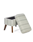 The matching footstool of the Luca rocking chair in cashmere vintage stripe and walnut opened, showcasing its storage capacities, in a white background.