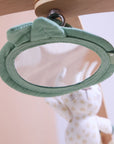 Close-up of Love Cats luxury wood muslin play gym mirror with soft sage trim, designed to encourage baby’s visual exploration.