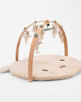 Angled view of Love Cats luxury wood muslin play gym with hanging character toys and soft padded mat.