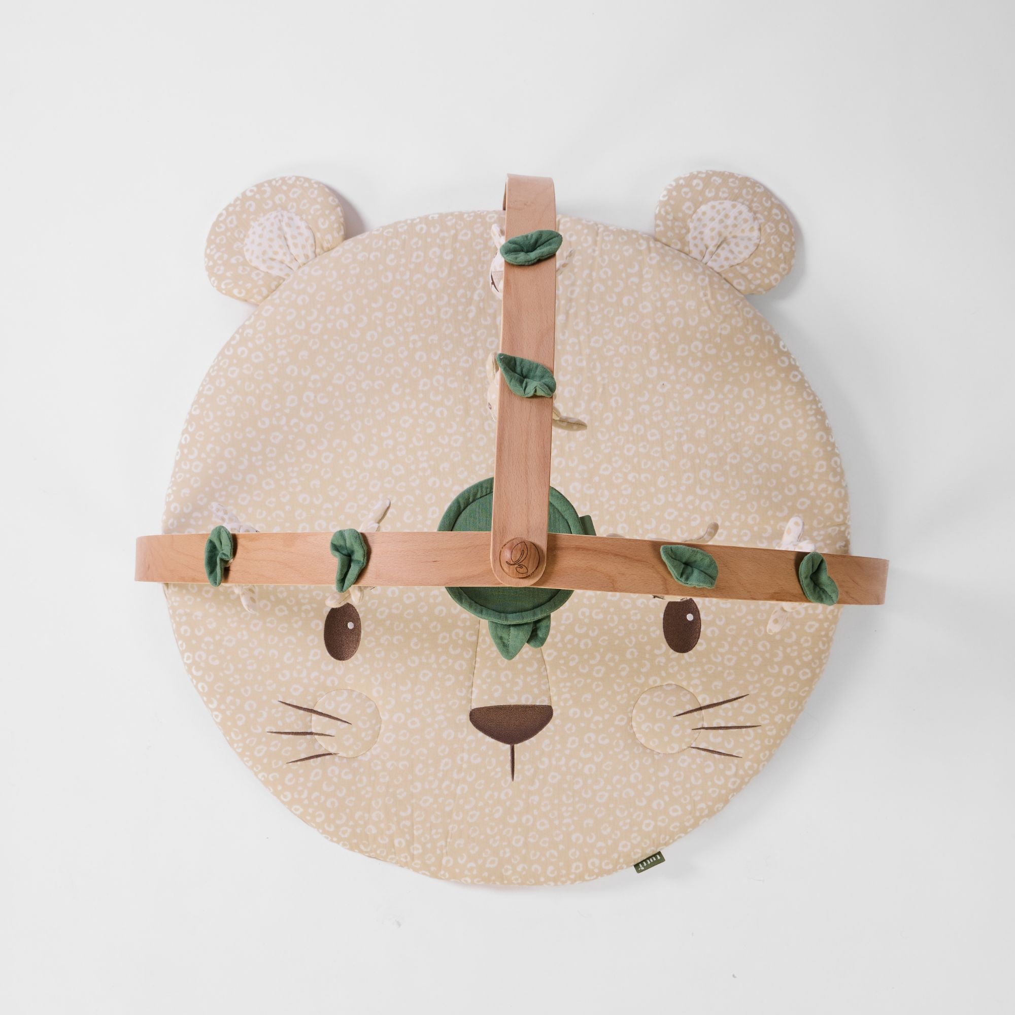Overhead view of Love Cats luxury wood muslin play gym with padded character mat and wooden cross frame.