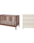 A nursery furniture set featuring a dark brown wooden cot bed with a mattress and a cream-colored three-drawer dresser with a changing unit, shown against a plain white background.