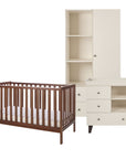 A baby nursery furniture set including a dark brown wooden cot bed with a mattress, a cream-colored changing table with drawers and shelves, and a matching tall wardrobe, shown on a plain white background.