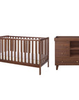 A cot bed and changing table set in matching dark brown walnut wood, shown on a plain white background.