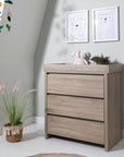 Modena Changing Unit Oak styled in a nursery setting, offering practical and stylish storage with a dedicated changing area for convenience