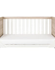 Front view of the Modena Cot Bed in White and Oak converted into a sofa bed, showcasing its versatile 3-in-1 functionality for long-lasting use.