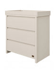 An angle view of the Modena changing unit in cashmere offers a modern look with three drawers and a removable changer.