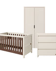 A three-piece nursery furniture set including a cot bed, a tall wardrobe, and a three-drawer dresser, shown on a plain white background. 
