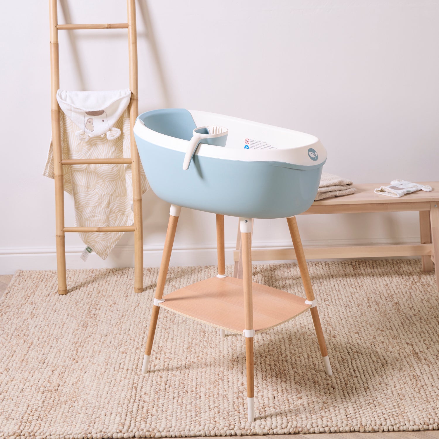 Nati Baby Bath in ocean with matching jug, designed for comfortable baby bath time.