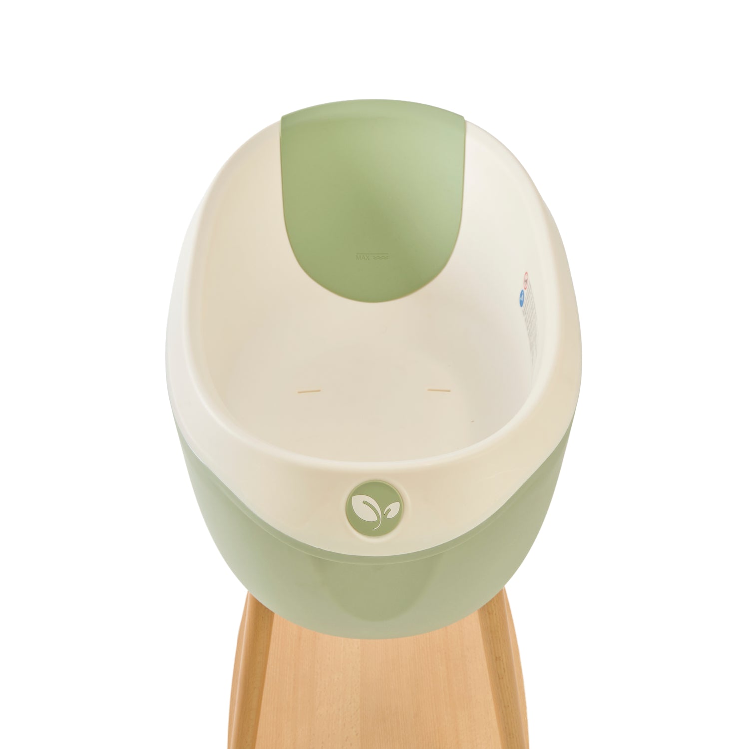 Inside view of the Nati Baby Bath with the silicone pad in Green, placed on its wooden stand against a clean white background.