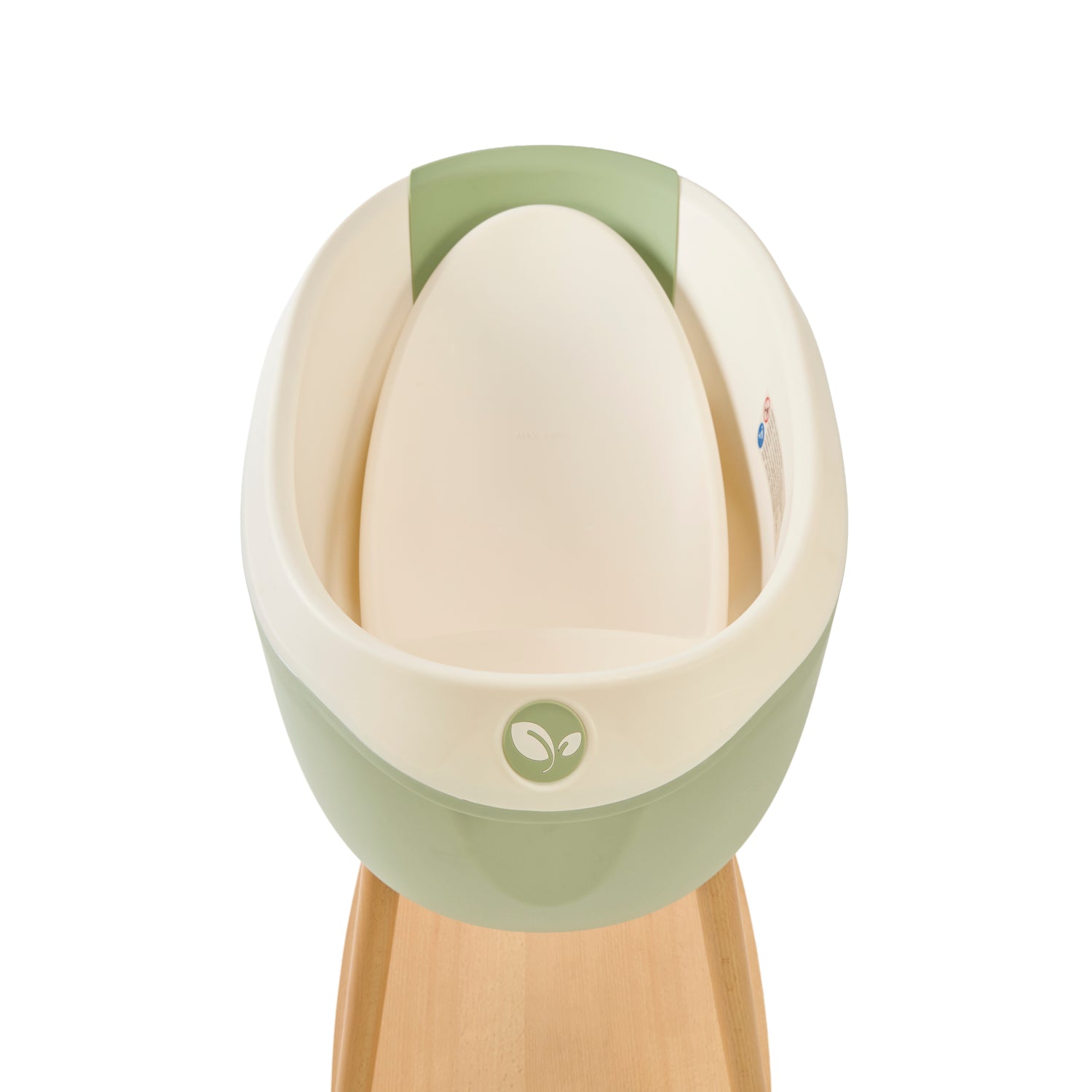 Inside view of the Nati Baby Bath in Green with the newborn insert, placed on its wooden stand against a clean white background.