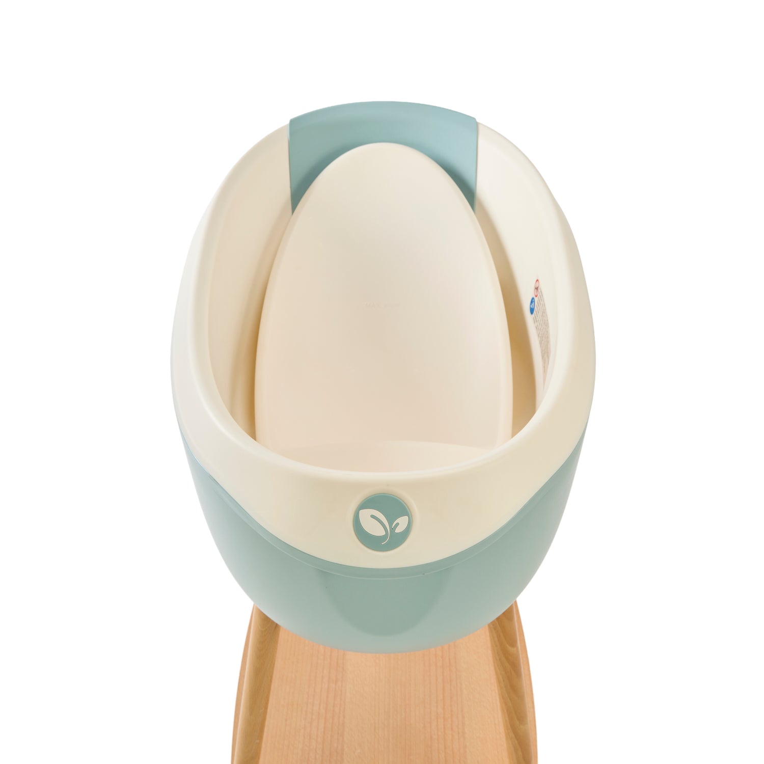 Inside view of the Nati Baby Bath in Ocean with the newborn insert, placed on its wooden stand against a clean white background.