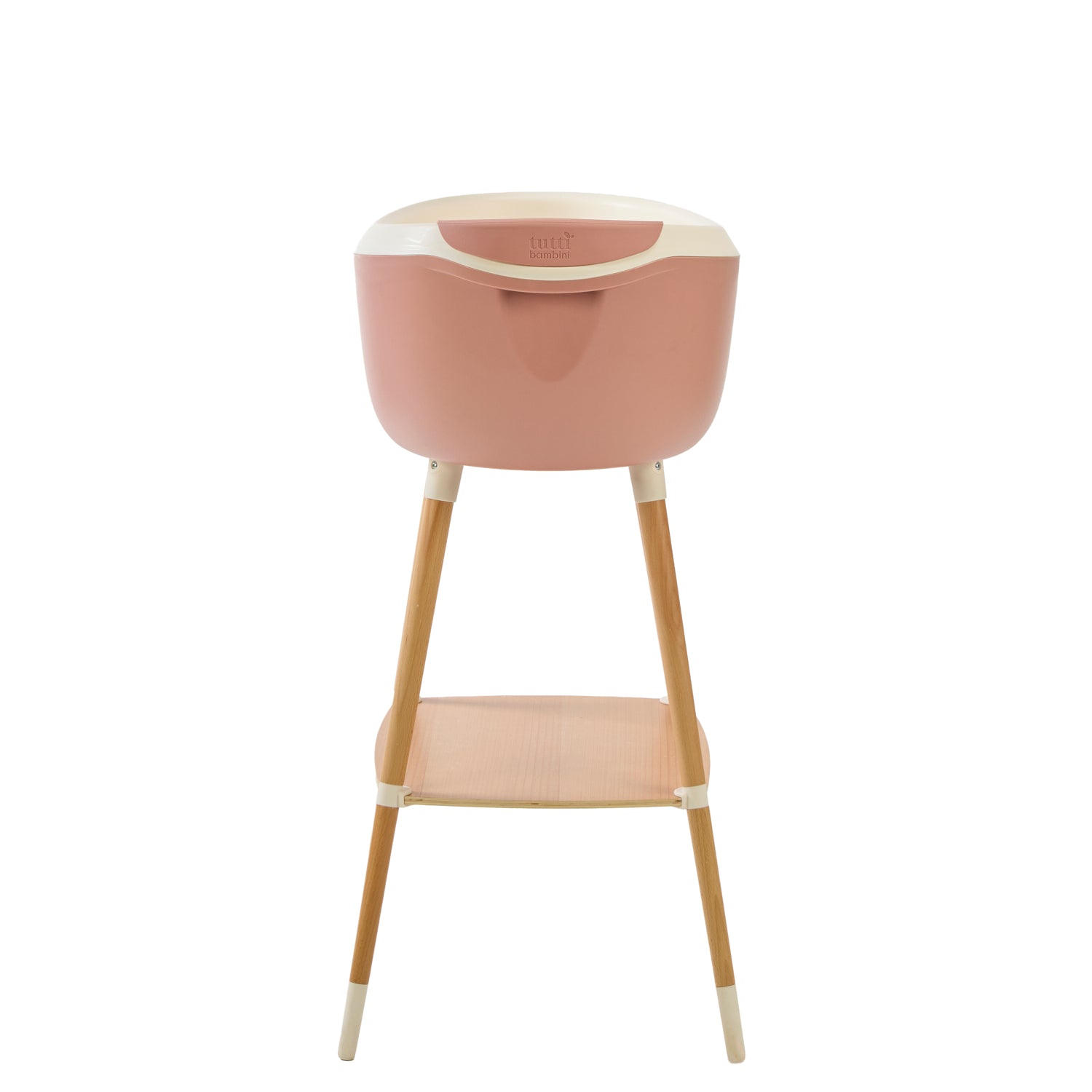 Back view of the Nati Baby Bath in pink on a wooden stand, in a white background.