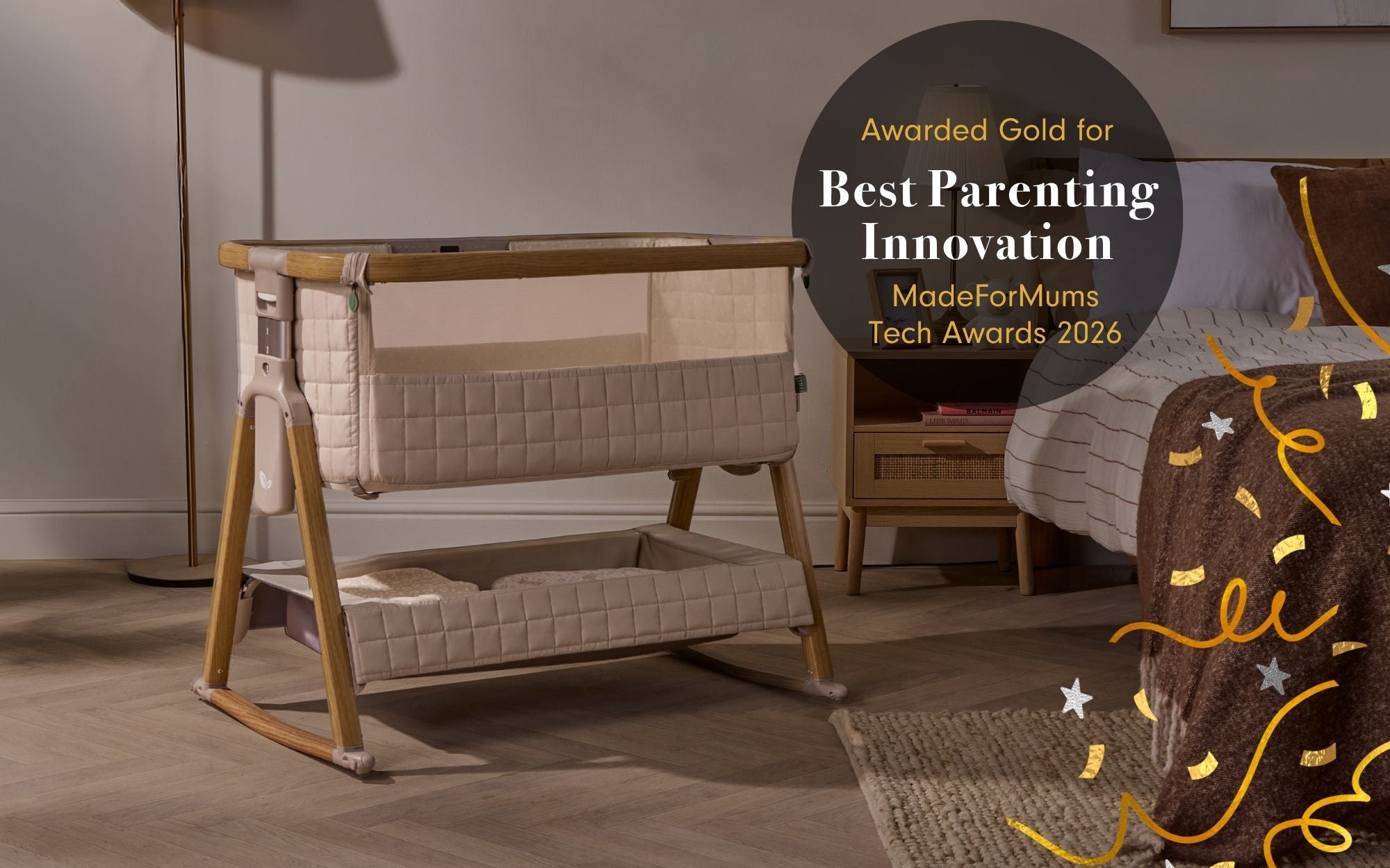 CoZee Sense next to me crib with a quilted beige fabric and light wood frame, shown in a styled nursery setting next to a bed. A circular award badge on the right reads 'Awarded Gold for Best Parenting Innovation MadeForMums Tech Awards 2026'.