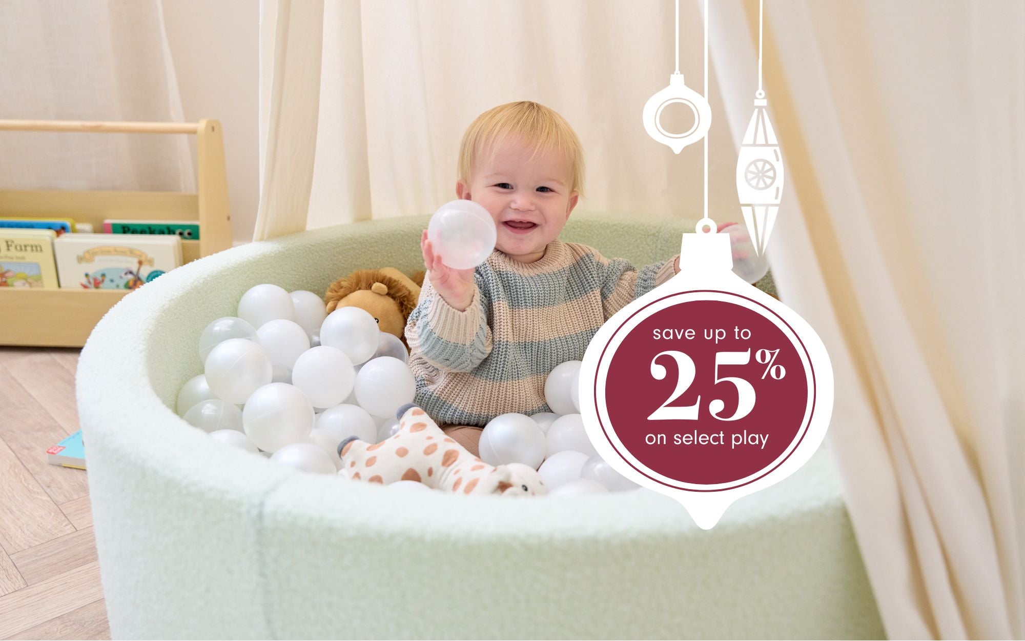 A child playing with balls in a ball pit with a promotional badge for a discount offer.