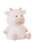 Side view of a white cow-shaped night light on a white background