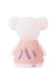 Night light with a pink dress featuring leaf designs on a white background