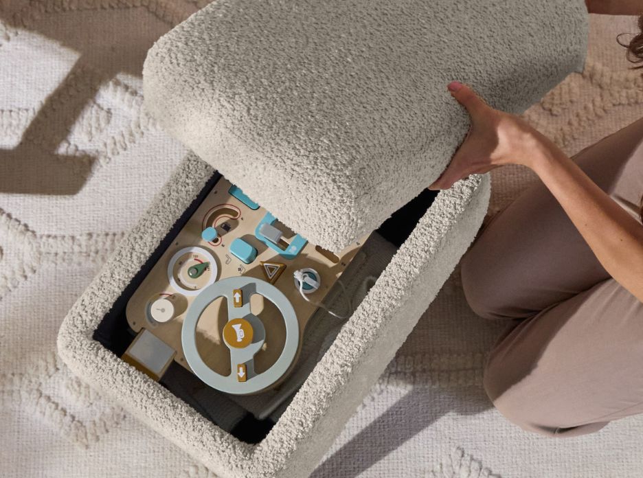 Footstool lid lifted to reveal hidden storage inside the Oscar Luxe Rocking Chair set in Teddy Mushroom, shown with neatly stored toys