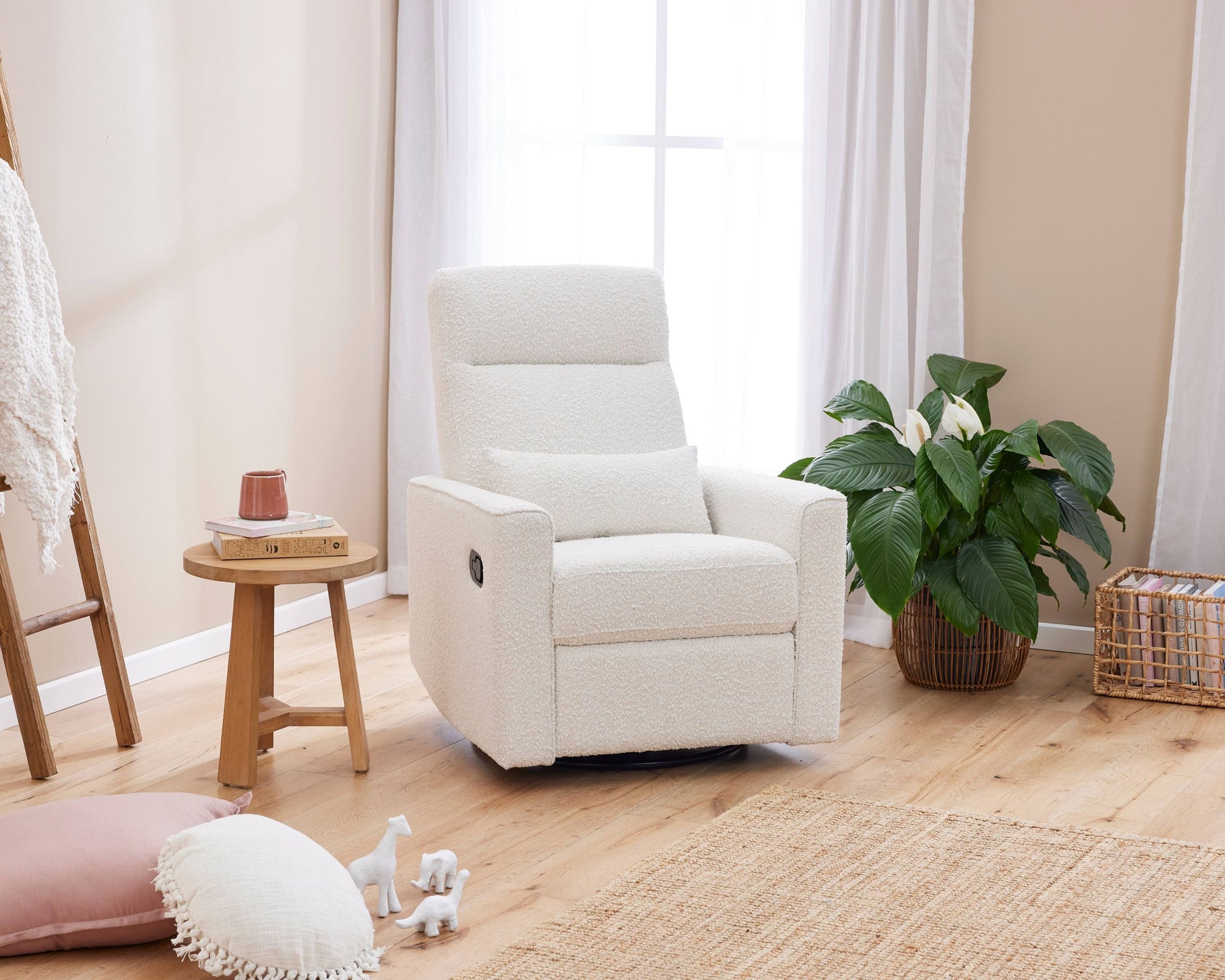 White recliner chair in a cosy living room with a plant and a small table.