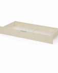 The Riley mini cot bed drawer in cashmere in a white background.