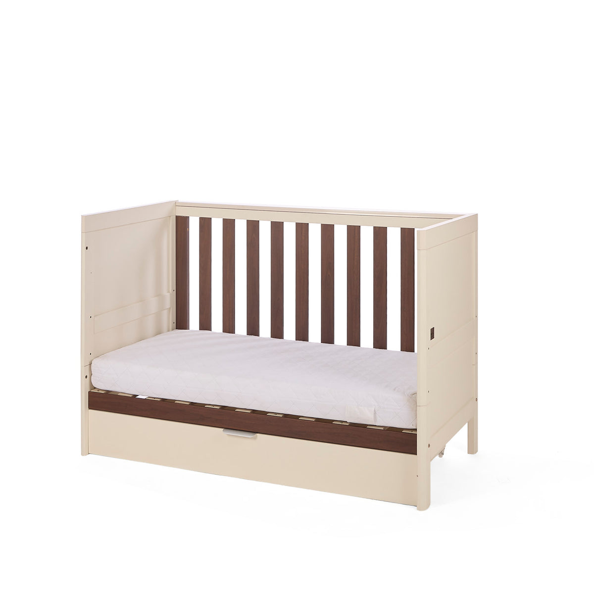 The Riley mIni cot bed in cashmere and rich walnut in sofa mode on a white background.