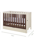 An infographic of a white cot bed with wooden panels showing dimension markings of 125 cm length, 65 cm width, and 84 cm height, on a plain white background.
