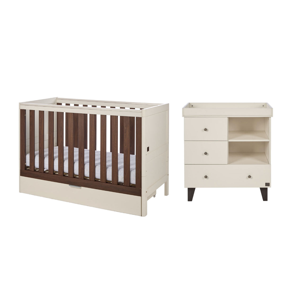 A nursery furniture set featuring a convertible cot bed and a matching changing table with three drawers, shown against a plain white background.