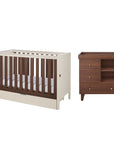 A nursery furniture set featuring a convertible cot bed and a dark brown wooden changing table with three drawers, shown against a plain white background.