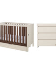 A nursery furniture set featuring a convertible cot bed and a matching chest changer, shown against a plain white background.