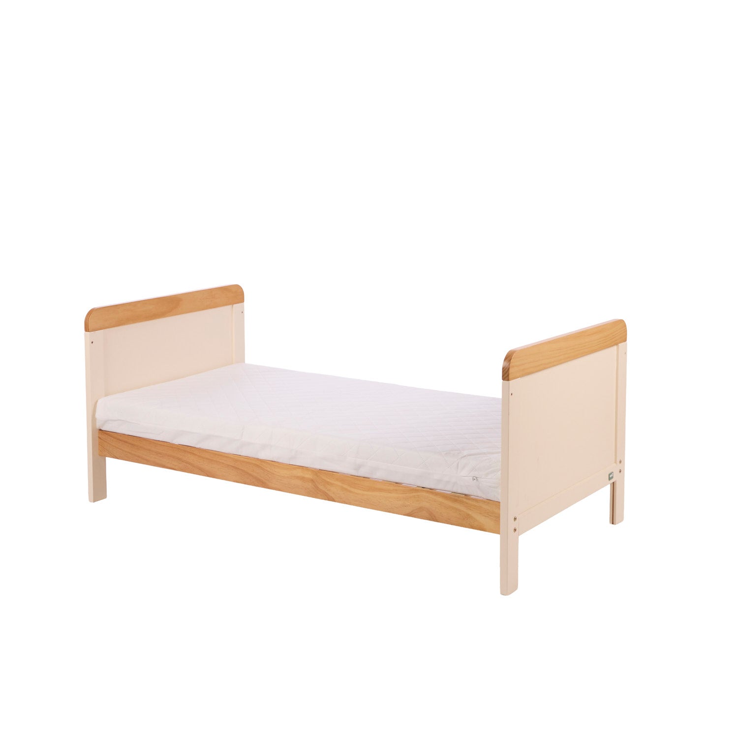 Rio cot bed in toddler bed mode in Cahsmere and Oak with a white mattress on a white background