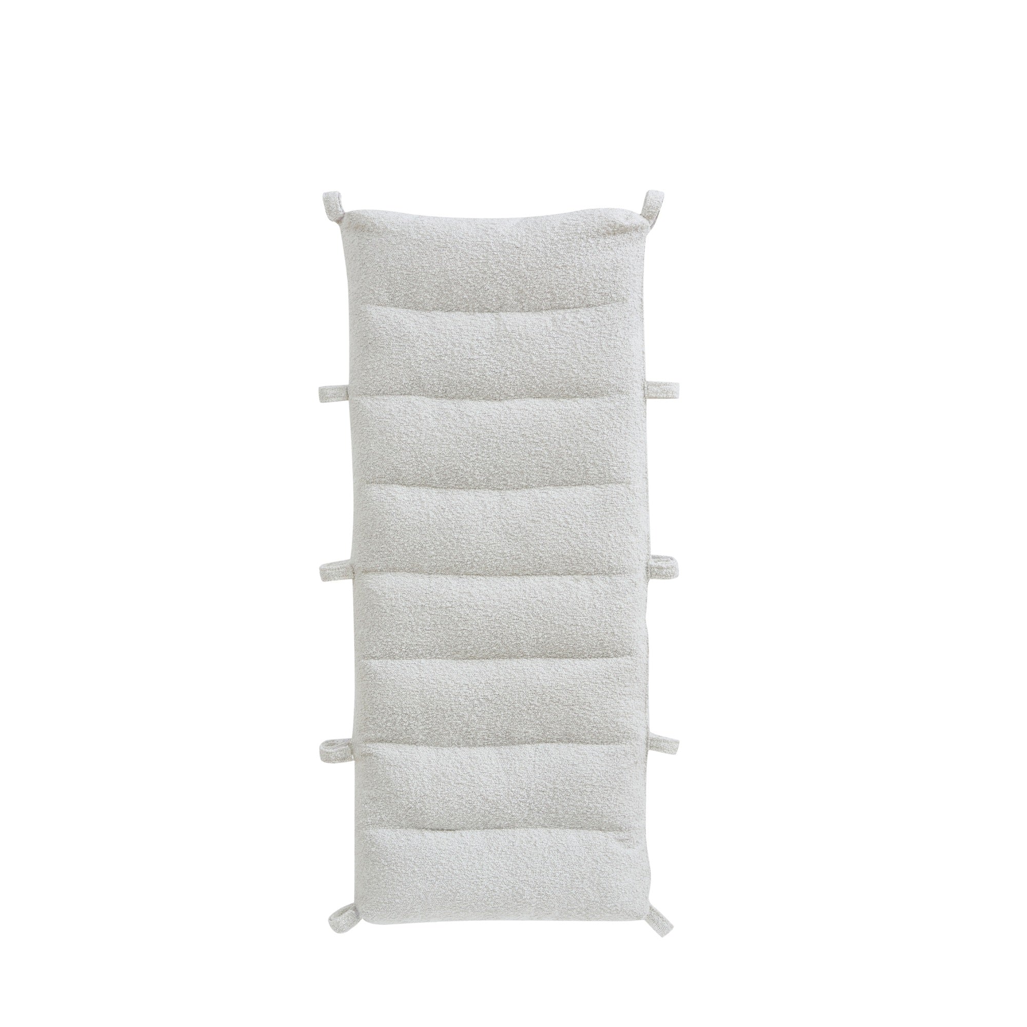 Cutout view of the Scala Montessori Pikler cushion in boucle natural with multiple fabric ties for secure attachment.