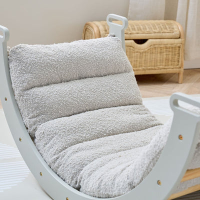 Close-up view of the Scala Montessori Pikler Cushion in Boucle Mushroom attached to frame, showing soft padding and warm neutral tones