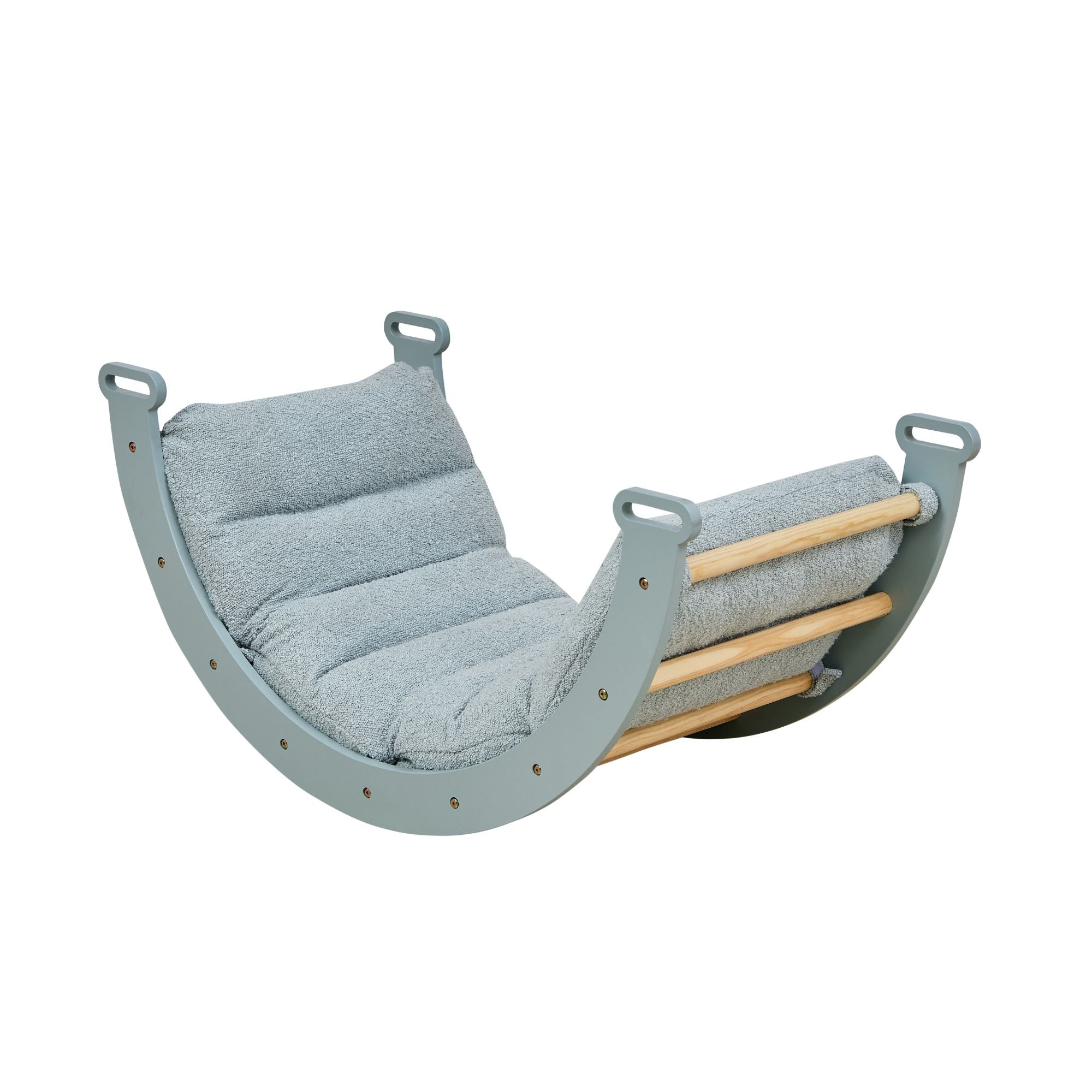 Angled view of the scala montessori pikler cushion in boucle ocean stone, showing padded support secured to the curved wooden rocking frame