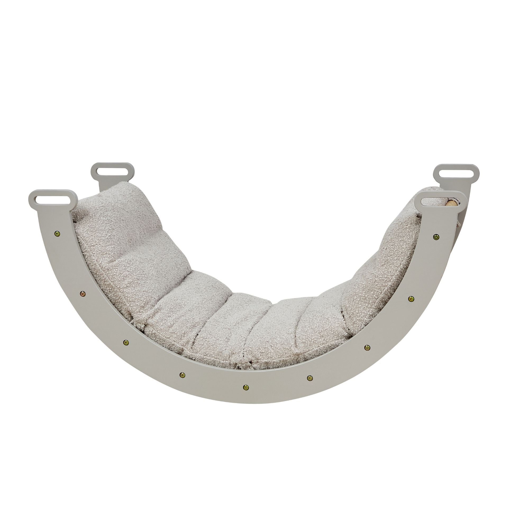 Side cutout view of the scala montessori pikler cushion in boucle mushroom, showing its soft padded support and secure curved rocker frame.