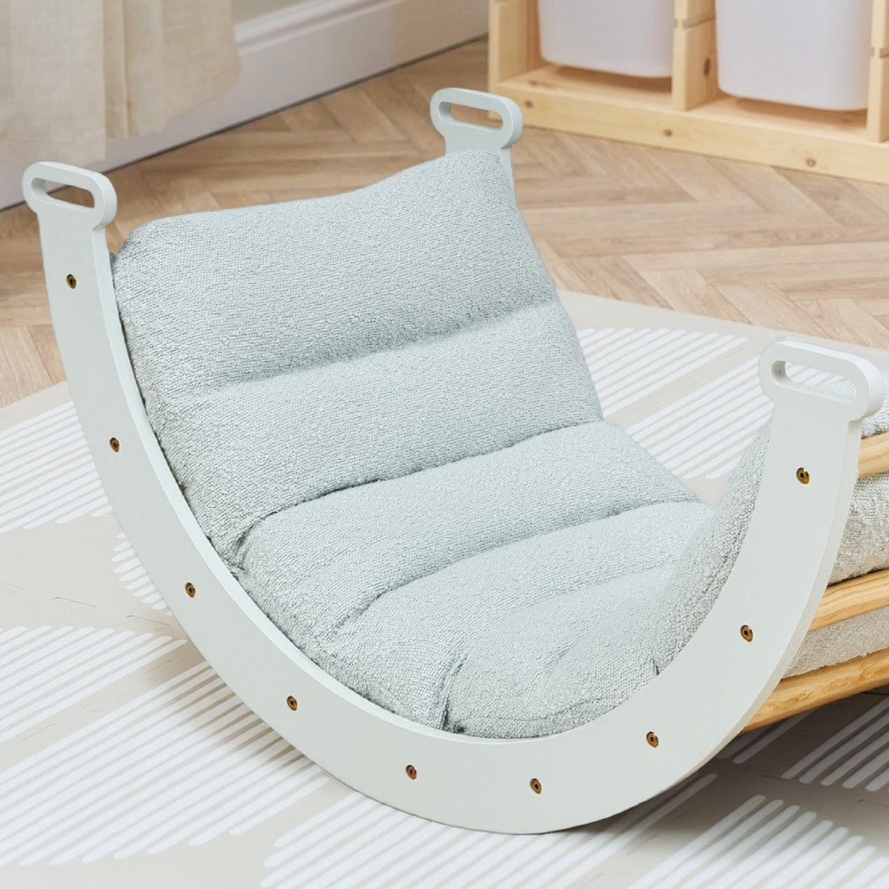 Rocker with a soft blue cushion on a wooden floor in a room setting