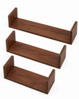 Front-facing view of three U-shaped wall shelves in walnut on a white background showcasing sleek and sturdy construction.