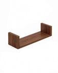 A close-up view of the U-shaped wall shelves in walnut showing the medium sized shelf.