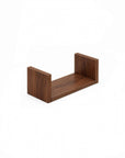 A close-up view of the U-shaped wall shelves in walnut showing the small sized shelf.