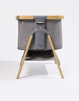 Side view of CoZee Bedside Crib in Oak and Charcoal 