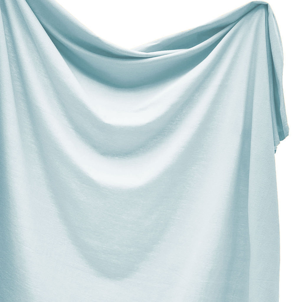 Light blue swaddle draped over a white background