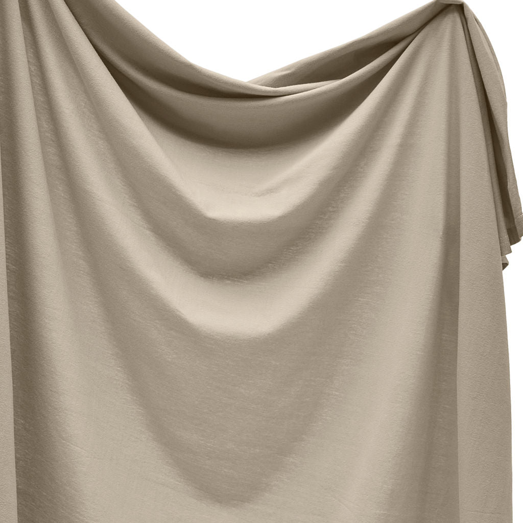 Beige swaddle draped over a white background