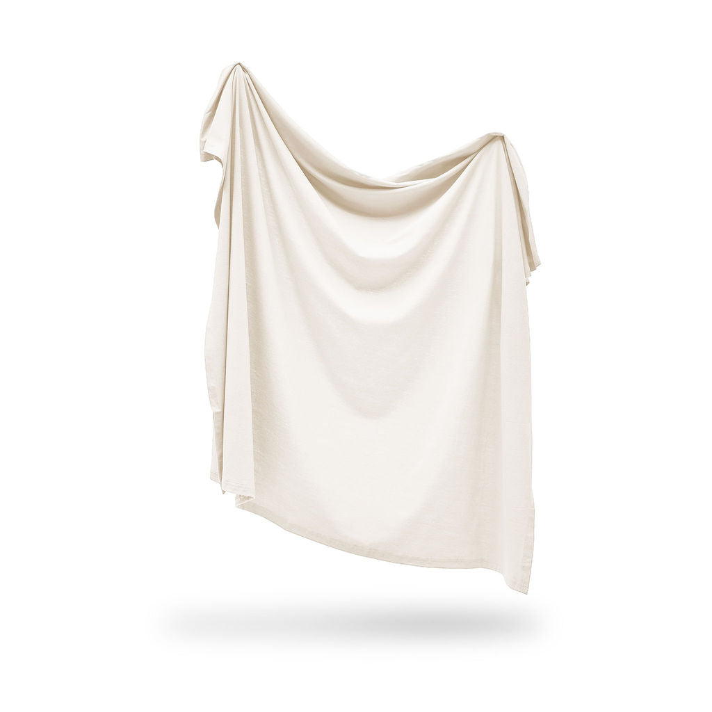 Beige swaddle draped over a white background