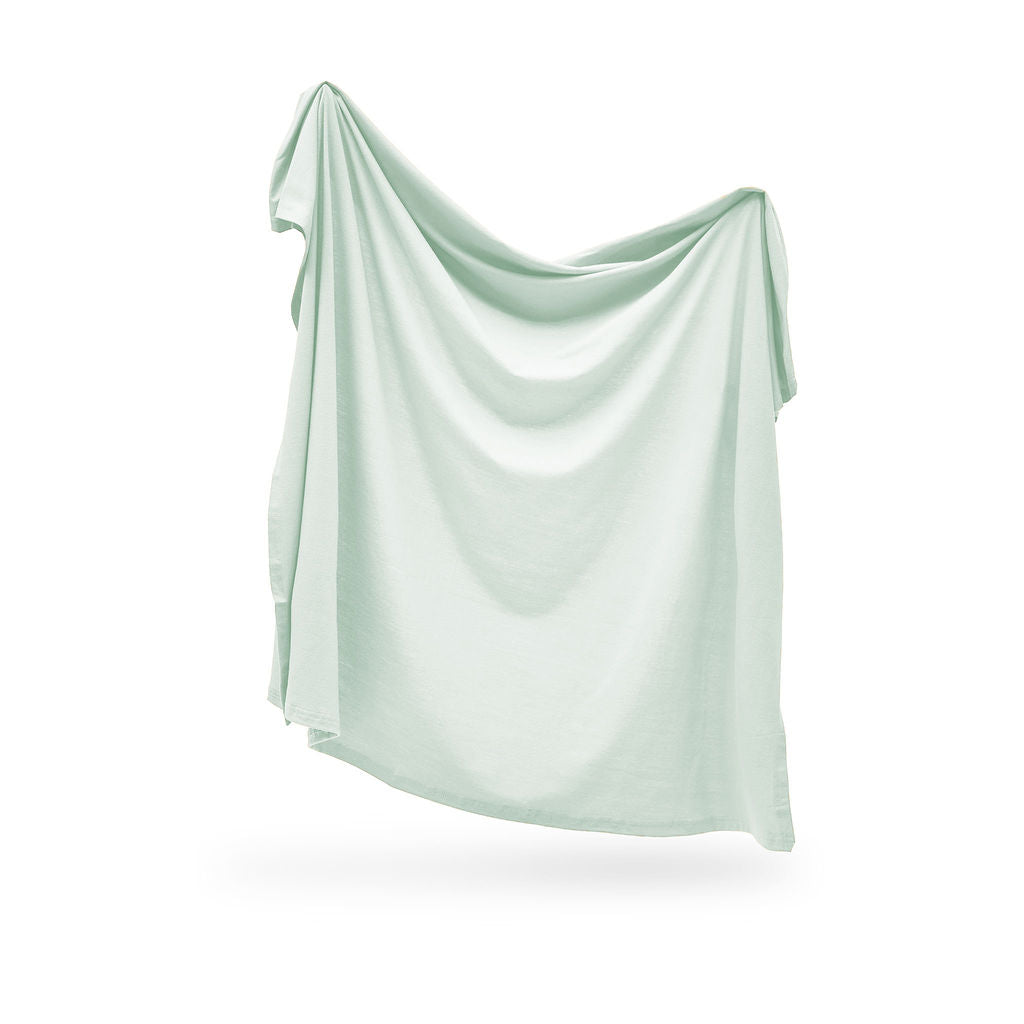 Light green swaddle draped over a white background