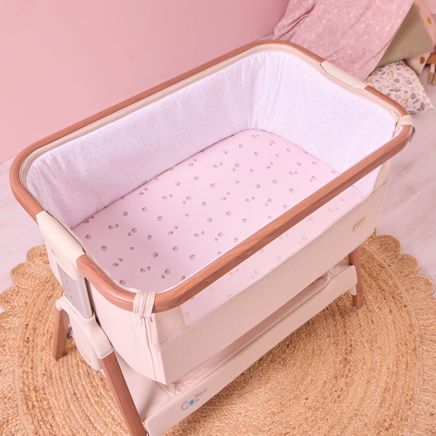 Baby crib with pink mattress cover in a room setting