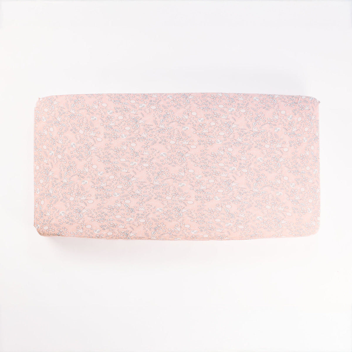 Tiny Tails cot fitted sheet laid flat on white background, highlighting detailed botanical pattern and soft cotton finish.